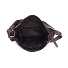 The brown bag unzipped from above, showing the lining and inner pockets
