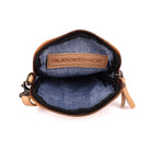 Sand phone bag unzipped, showing the blue fabric lining and a stamped leather tab