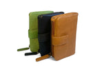 Leather wallets standing in a fan in apple green, black and tan