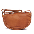 Tan leather half-moon cross body bag, the strap gathered above it
