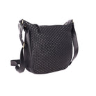 Black woven sling bag angled to the side, showing the weave and the strap fixing