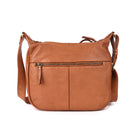 Back of the tan sling bag in smooth leather, with a zip pocket across it