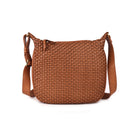 Tan woven leather sling bag from the front, with a rounded base and long strap