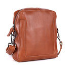 Cognac sling bag angled, showing the side seam and strap clip