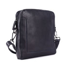Navy leather sling bag angled, an upright squared body with a clip-on strap