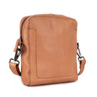 Nude sling bag angled, showing the side seam and strap clip