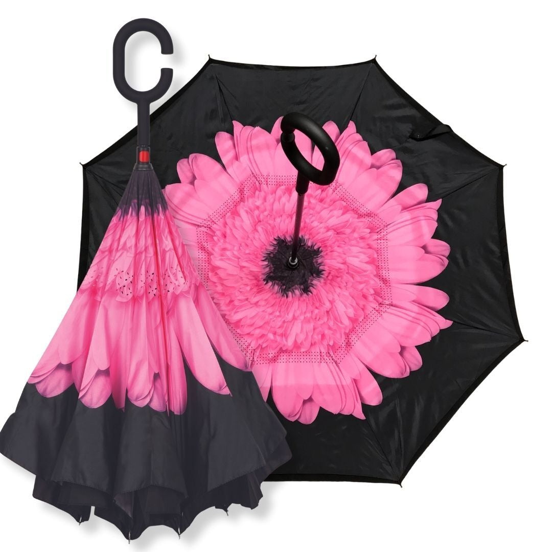 IOco reverse umbrella in Pink Gerbera design with giant pink bloom inside a black canopy and C-loop handle