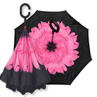 IOco reverse umbrella in Pink Gerbera design with giant pink bloom inside a black canopy and C-loop handle