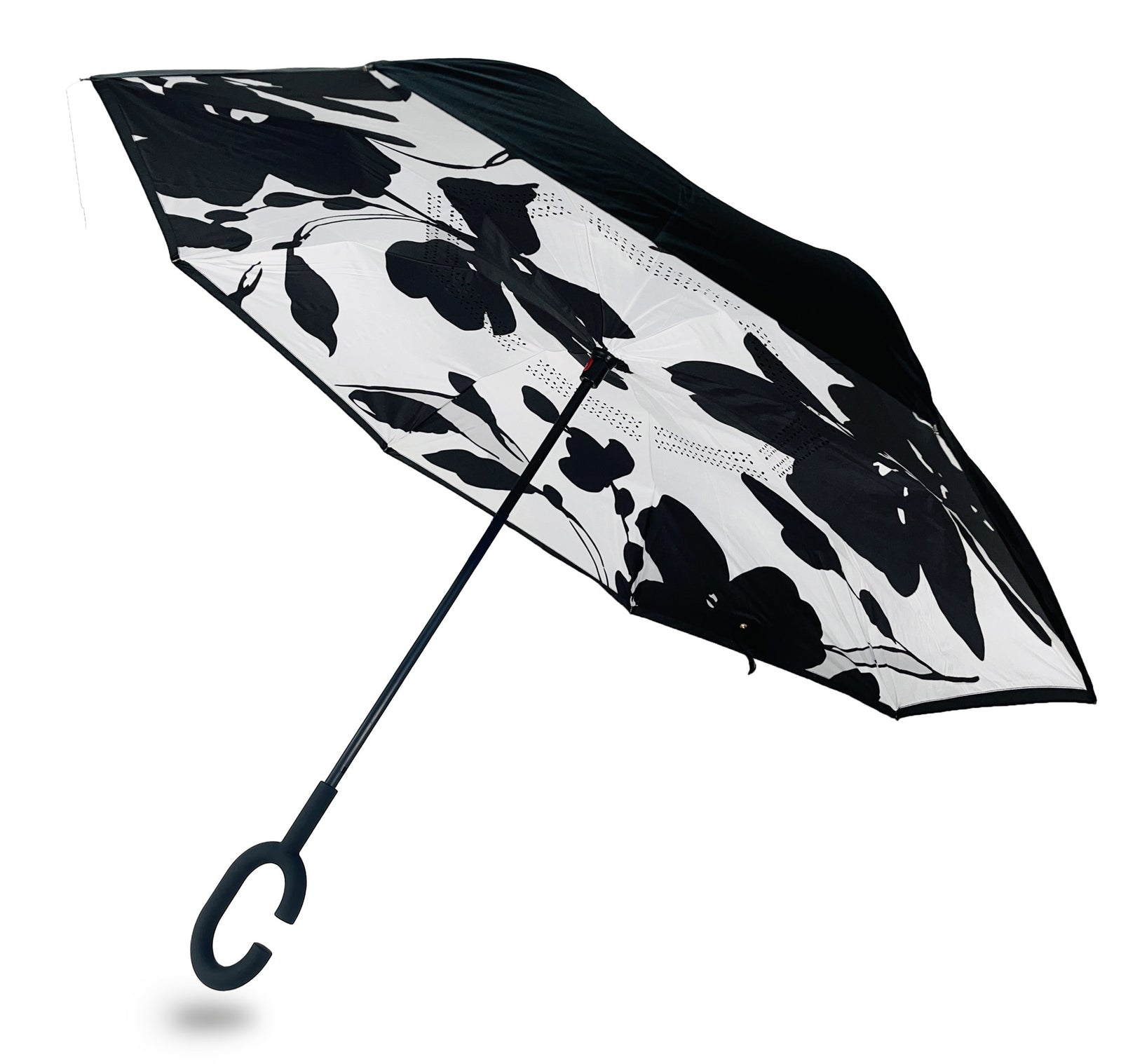 Reverse umbrella with black botanical silhouettes on white inside a black canopy