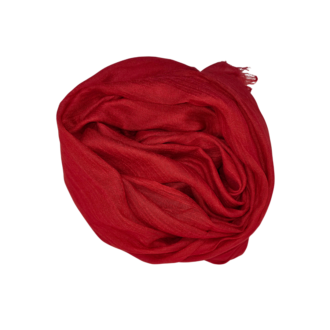 Beauty in Bamboo scarf in Ruby Red, a deep crimson, rolled into a smooth bun