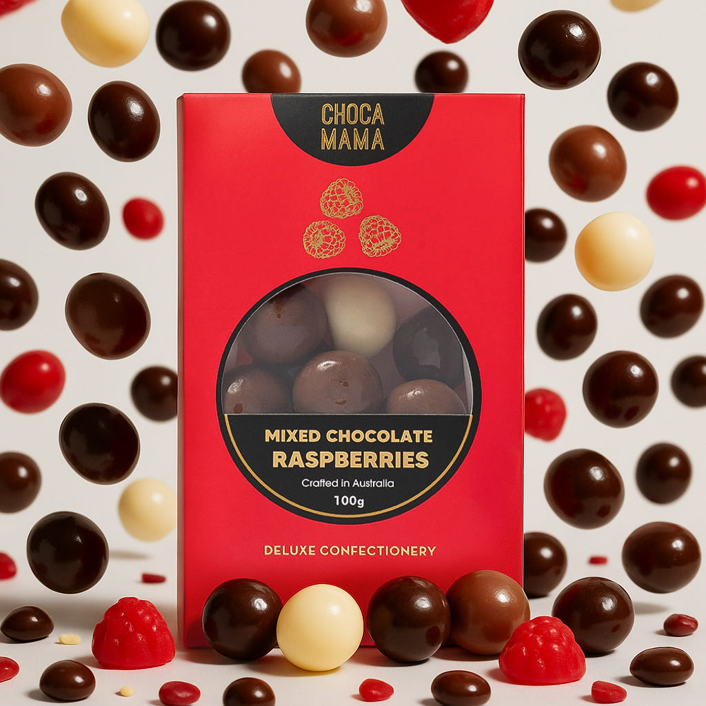 Mixed chocolate raspberries box surrounded by scattered chocolates and raspberry jellies
