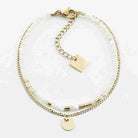 Double-row bracelet with a strand of pale mother-of-pearl beads beside a fine gold curb chain