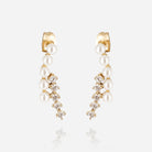 Pair of gold drop earrings, each a curve of pearls and clear crystals hanging from a plain gold stud