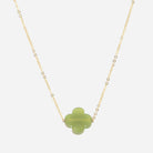 Fine gold chain necklace with a pale green glass four-leaf clover pendant
