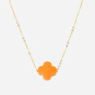 Fine gold chain necklace with an orange glass four-leaf clover pendant