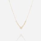 Fine gold chain necklace with a small crystal-set cross pendant and stones along the chain
