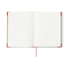 The journal open to its lined ivory pages