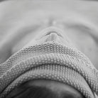 Woman relaxing with a rolled Salus cotton wash cloth across her eyes