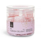 Clear round tub of pink rose Turkish delight cubes with a lilac label patterned in gold stars
