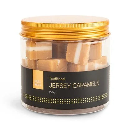 Clear tub of striped jersey caramel cubes with a gold screw lid and a black label dotted in gold