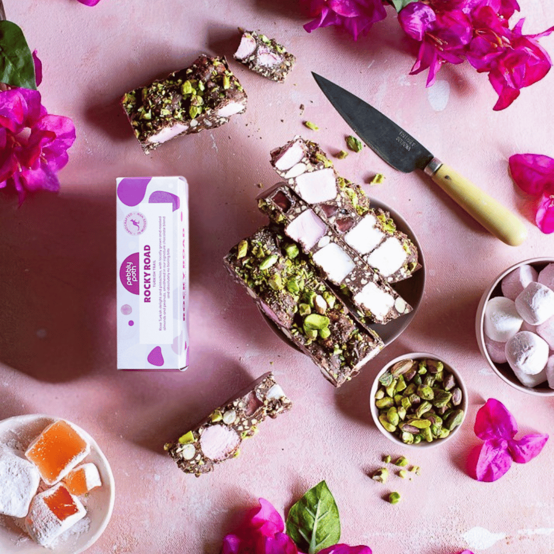 Pebbly Path Turkish Trail rocky road 100 g box with cut slices, pistachios, marshmallows, Turkish delight and pink bougainvillea, seen from above
