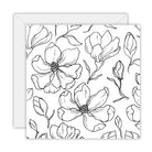 Square white card covered in black line drawings of magnolia flowers and buds, on a white envelope