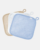 Three Toshi baby washcloths in blue, white and sand cotton towelling, each with a hanging loop