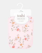 The bib on its Toshi hanging card, labelled baby bib knit in 100% cotton
