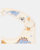 Close-up of the dinosaur bib's shoulder press studs and neat cream bound edging