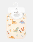 The dinosaur bib on its Toshi hanging card, labelled baby bib knit in 100% cotton