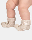 Baby wearing Toshi Organic Booties Yummy in oatmeal cable knit with pompoms