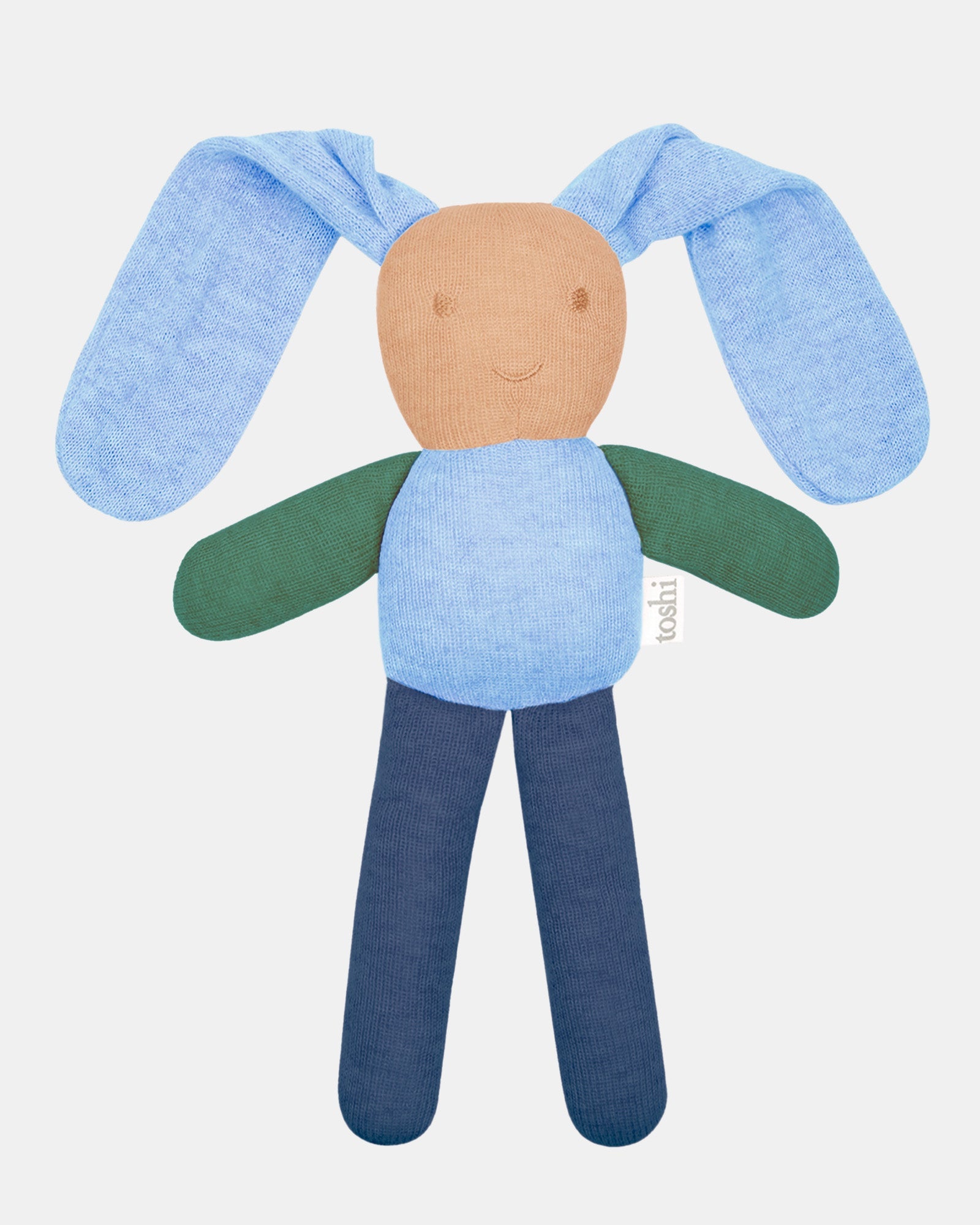 Toshi Bunny Bobby knitted comforter in bluebell — long floppy pale blue ears, a tan face with an embroidered smile, green arms and navy legs