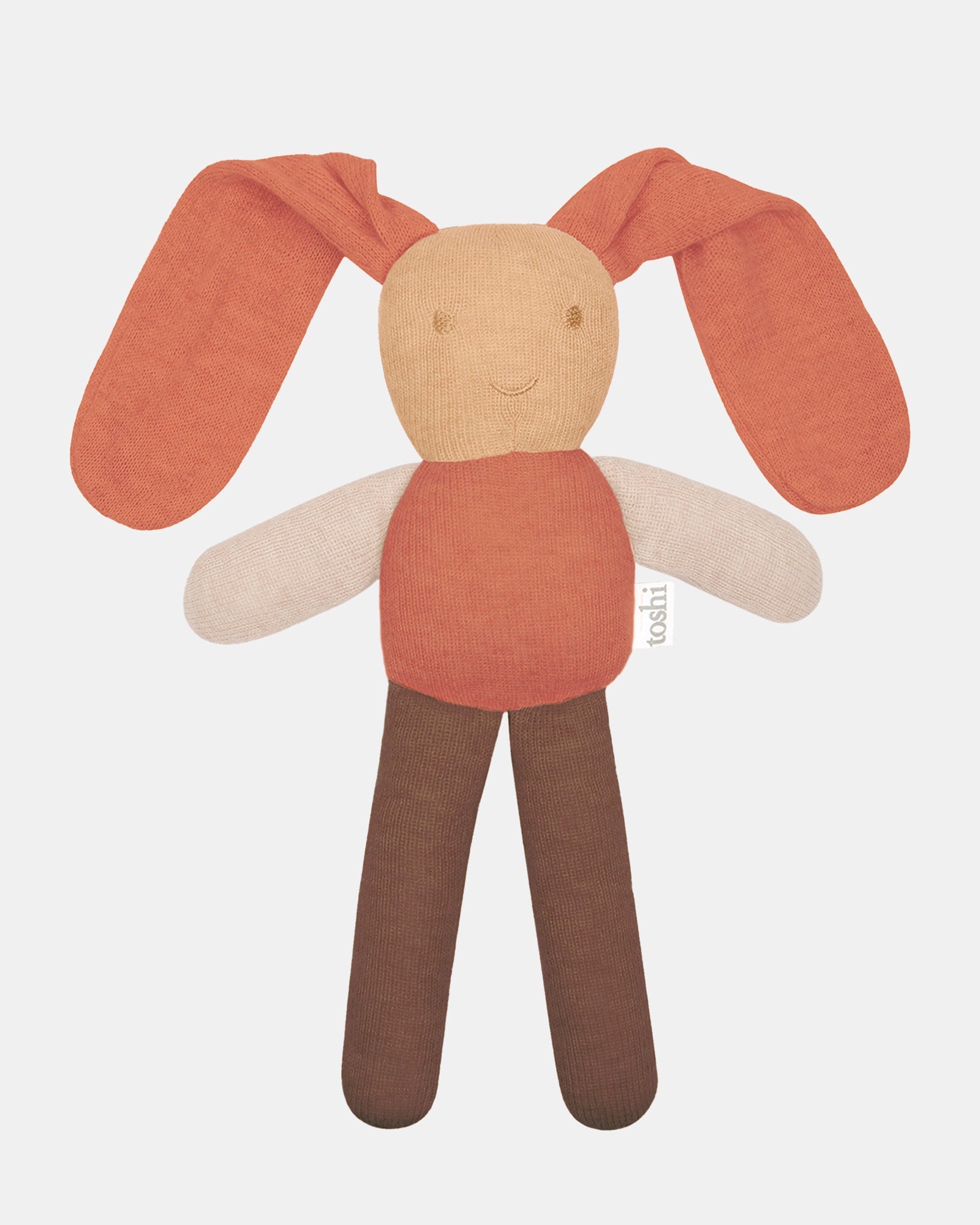 Toshi Bunny Bobby knitted comforter in oatmeal — long floppy terracotta ears, a wheat face with an embroidered smile, cream arms and chocolate legs