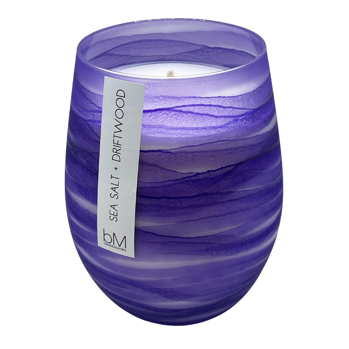 Wave Purple Sea Salt and Driftwood soy candle in a rippled violet glass vessel with a single wick