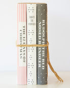 Spines of the three Christmas book stack titles - Frosty the Snowman, 12 Days of Christmas, Rudolph