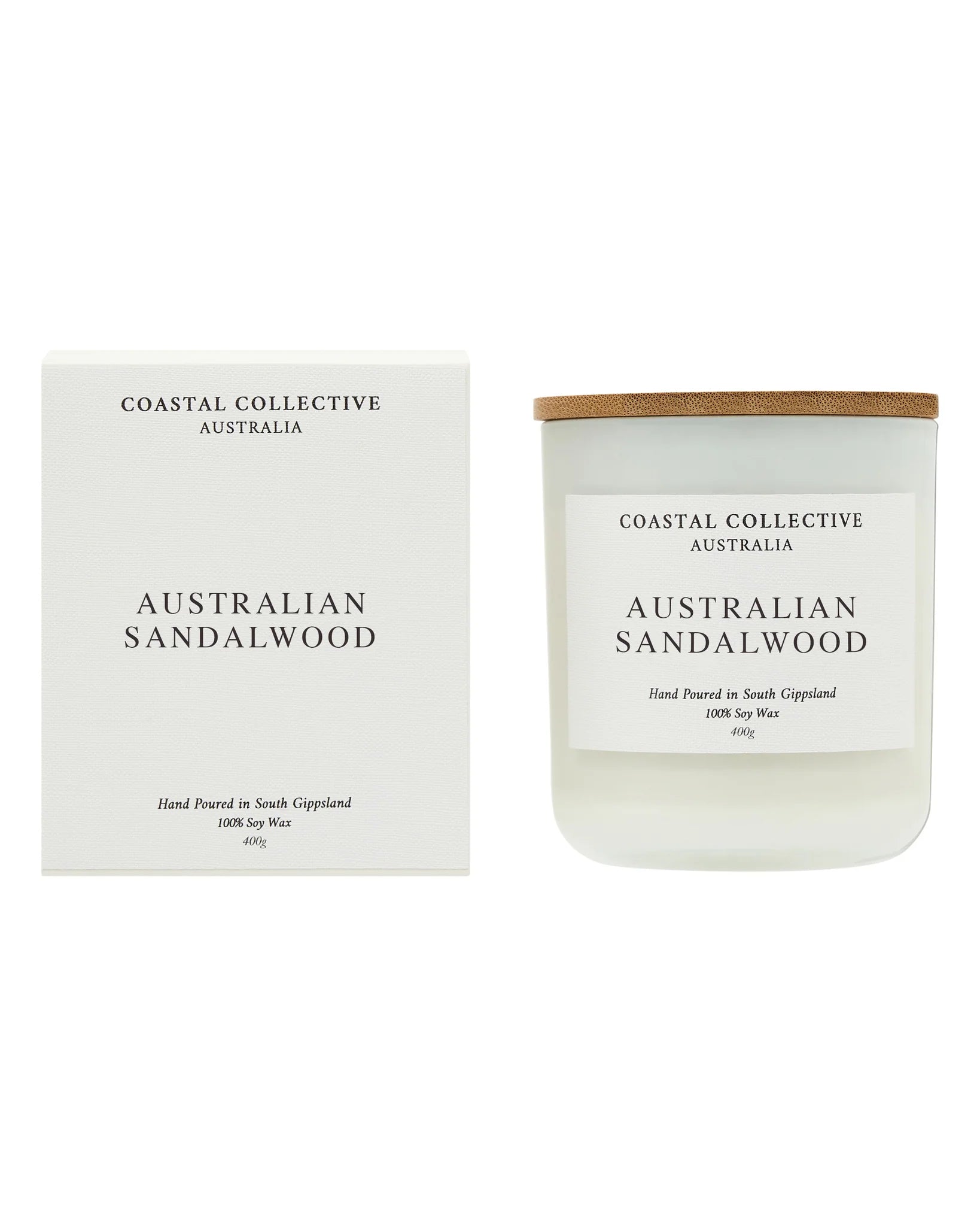 The Australian Sandalwood candle standing beside its plain cream gift box.