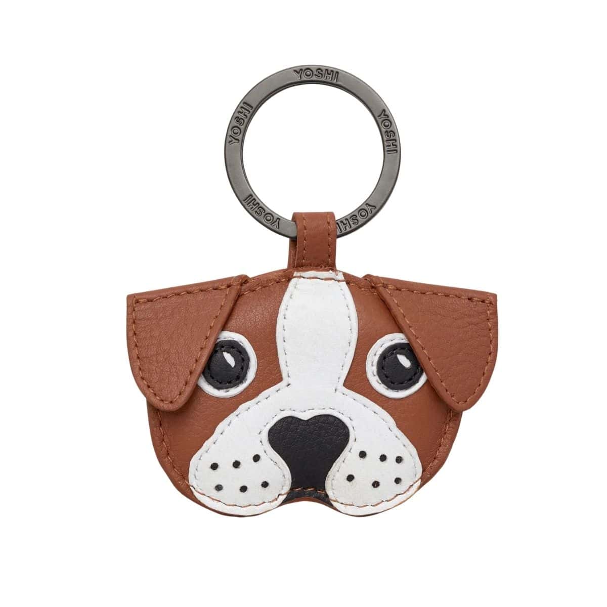 Tan leather keyring shaped like a dog's face, with white and black appliqué eyes, muzzle and nose, on a gunmetal split ring stamped Yoshi.