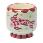 The Koi candle close up: a pink koi and gold stars hand-painted on a mint ceramic pot.
