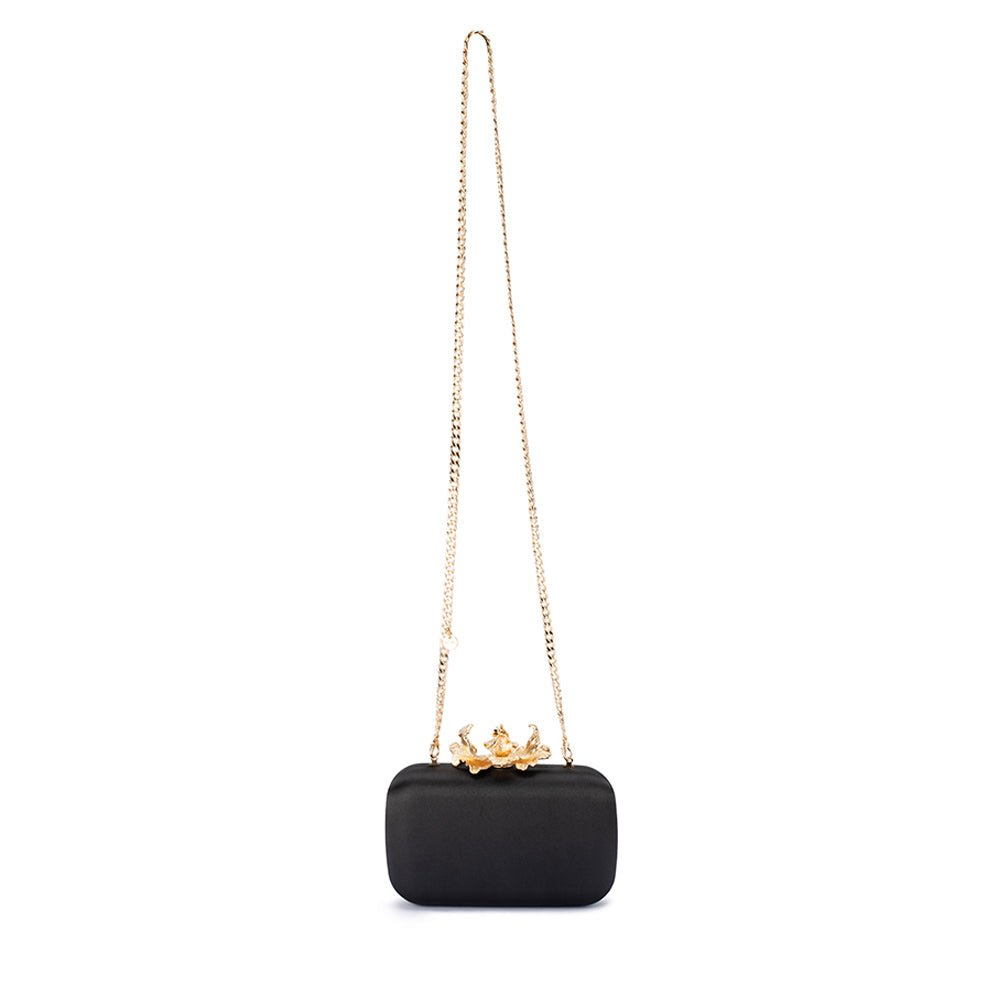 The black clutch hanging from its long gold chain