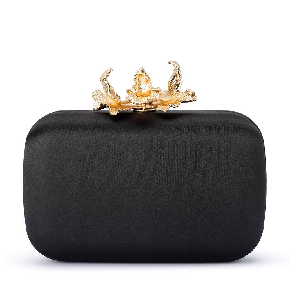 Black satin clutch from the front, a gold orchid clasp on top