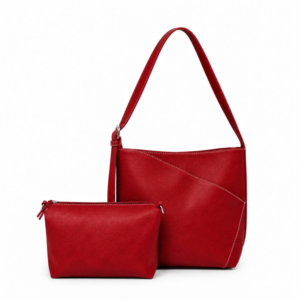 Red shoulder bag with curved front seams, shown with its separate red mini cross body bag in front.
