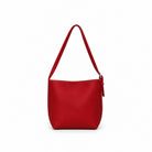 The other side of the red shoulder bag on its single strap.