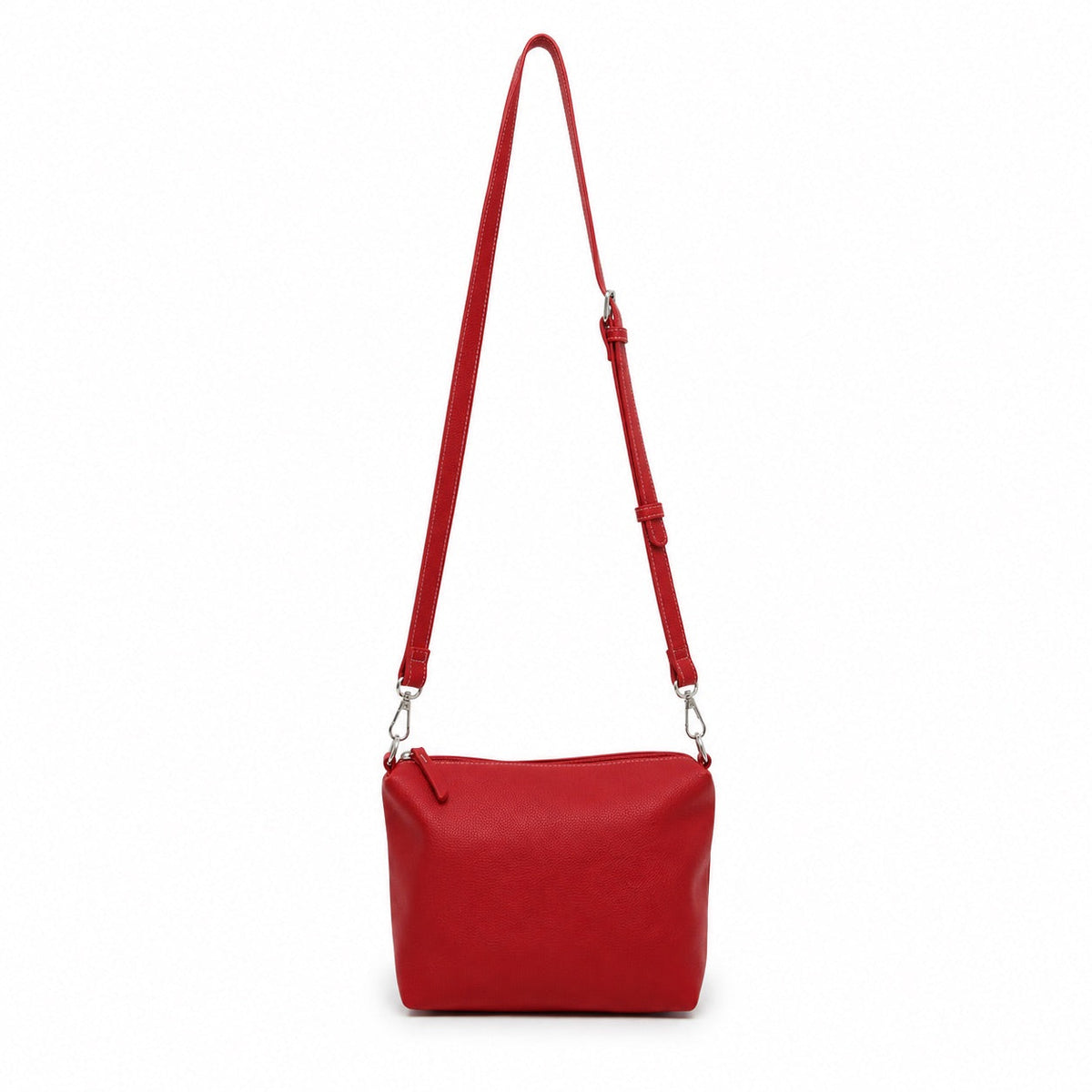 The red mini cross body bag hanging from a long adjustable strap.