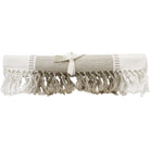 Natural table runner rolled and tied with a cream ribbon