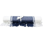 Navy table runner rolled and tied with a cream ribbon