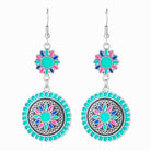 Silver hook earrings with an aqua, pink and blue enamel flower above a beaded circular drop