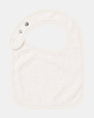 Back of the Gumnut Babies bib showing its cream cotton towelling lining and press studs