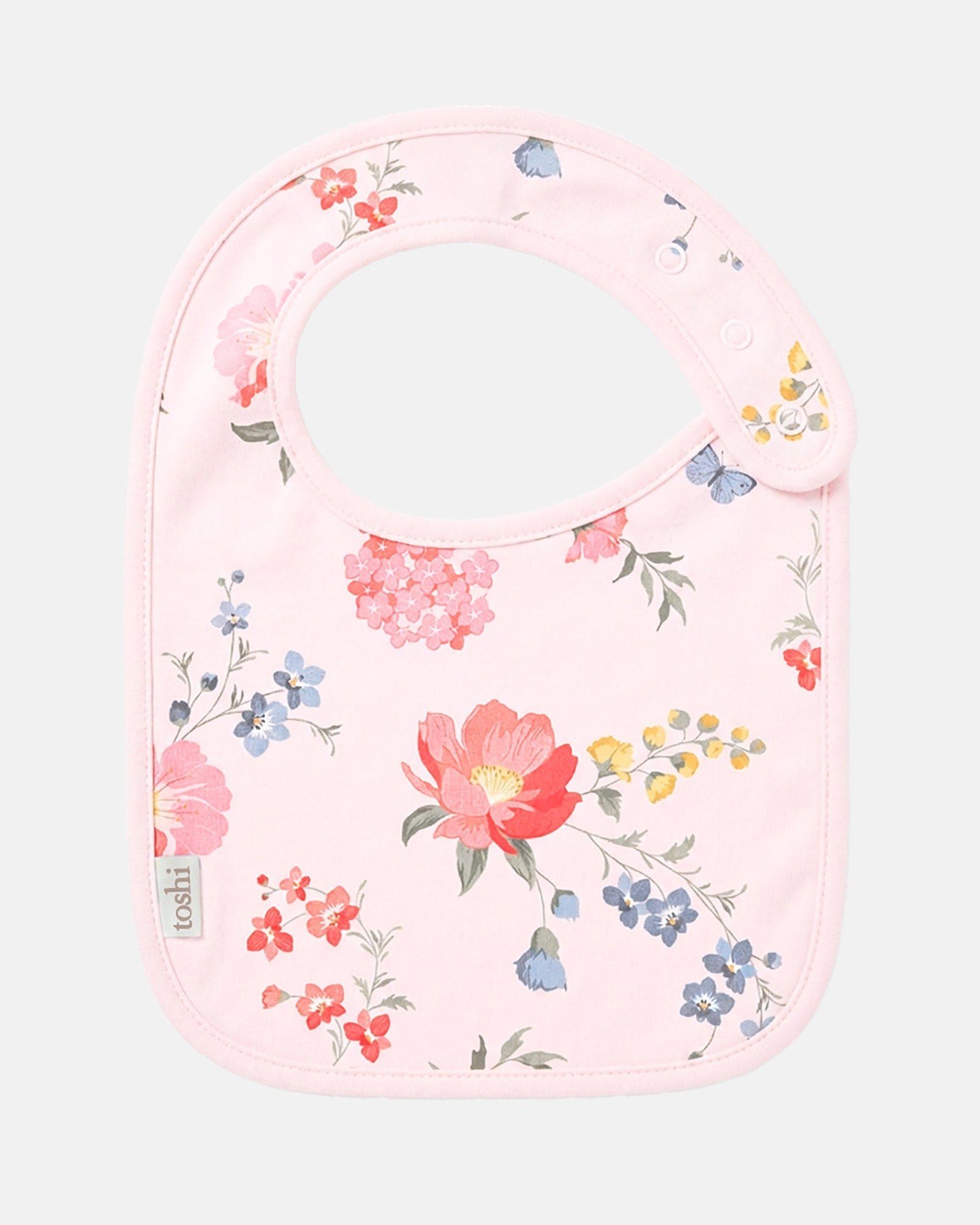 Toshi Arcadia Wild Garden baby bib in pale pink cotton printed with coral, pink and blue florals with butterflies
