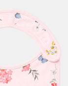 Close-up of the press-stud neck tab with florals and a blue butterfly