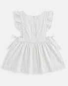 Back of the Florence pinafore showing the frilled straps and side ties